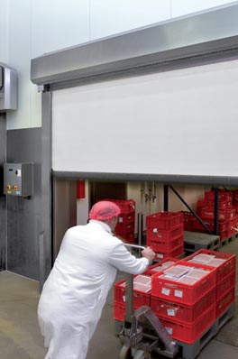 Food Processing Door Opened Halfway with a Man Pushing Products Through on a Skid