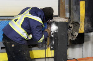 technician welding dock bumper