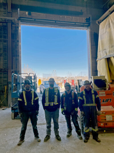 Calgary team in front of installed rubber door