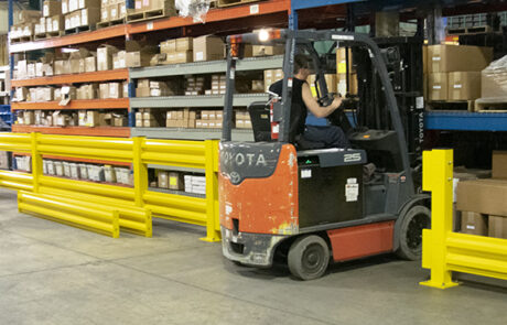 Steel Guardrail Systems warehouse guarding railing lifts out rails with forklift driving through