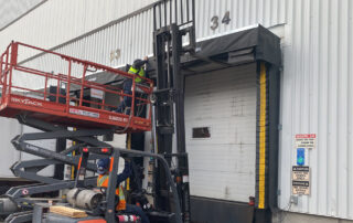 blue giant rain shroud dock canopy dock seal installation technicians forklift scissor lift